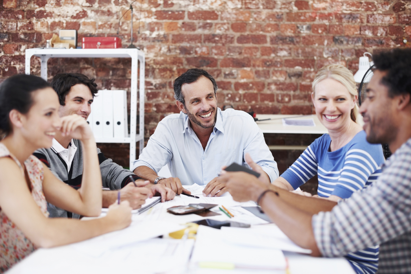 A team of hard-working, young architects brainstorming with each other at the office